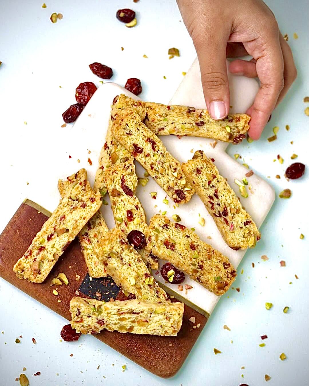 Cranberry and pistachio biscotti on a wooden board